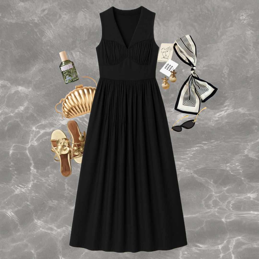 Black dress with accessories on a gray marble background