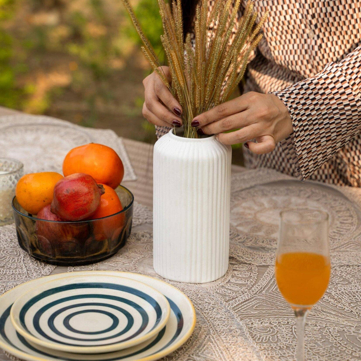 White ceramic vase filled with rustic dried grass for minimal and elegant home decor styling