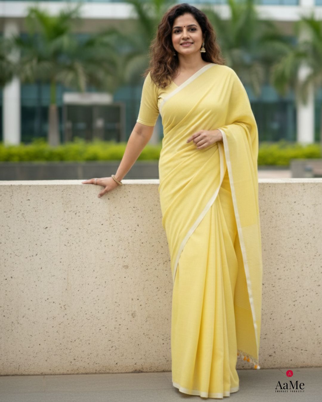 Women wearing handcrafted yellow handloom cotton saree designed for office wear with a clean and elegant look