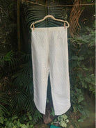 Selene Pants- Kosa Silk with Gold Weave | Jhultaru. Fabric: 100% Handwoven Kosa Silk  Color: Ivory White with golden zigzag weave  Design: Straight fit, high-waisted with gently rounded hem slits, full length- Selene Pants in kosa silk with a soft zigzag weave. Straight fit with curved hem. Designed for elegance and ease. Pair with the Selene Kurta.