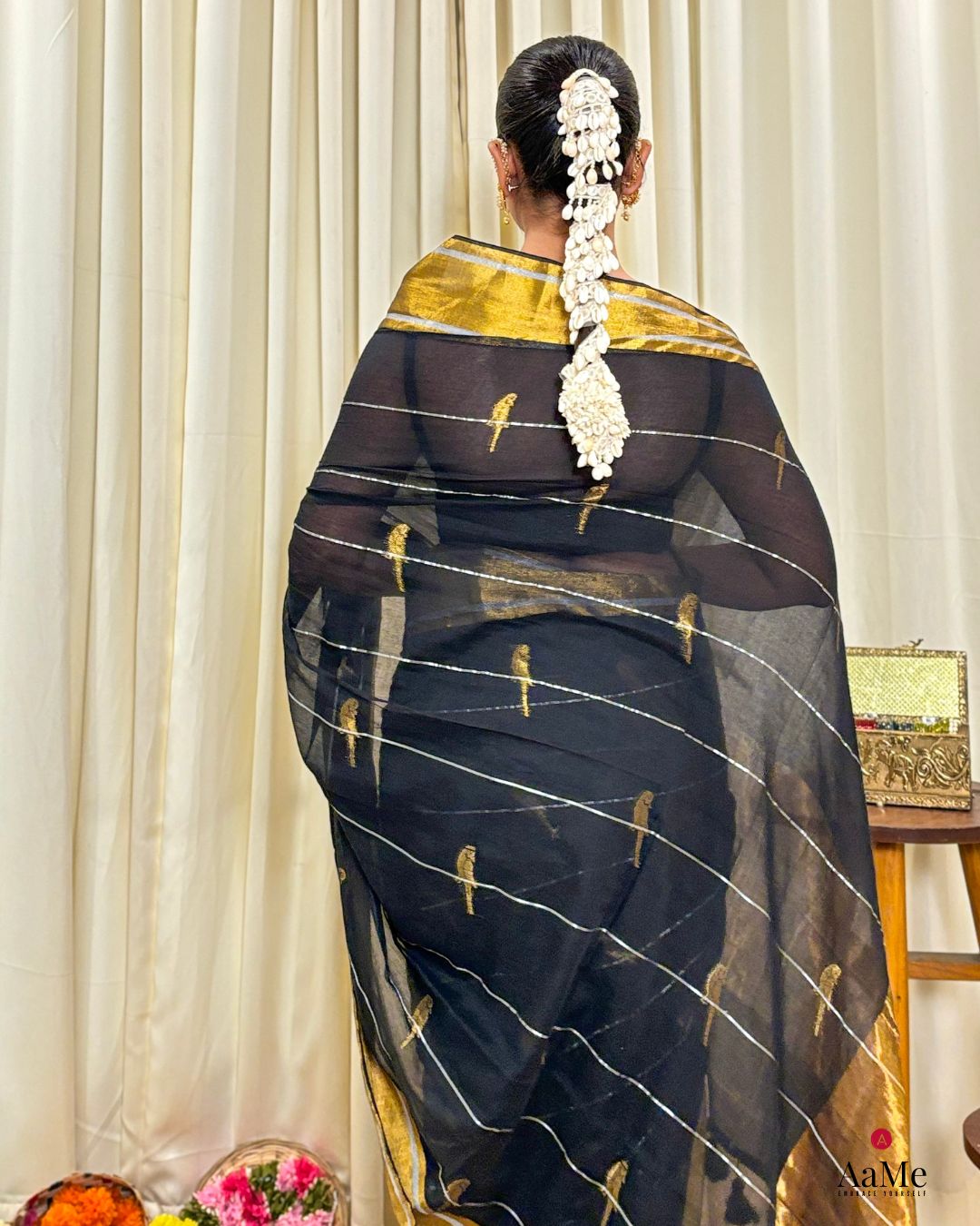 Women wearing soft black mulmul saree in breathable cotton, perfect for elegant evening celebrations