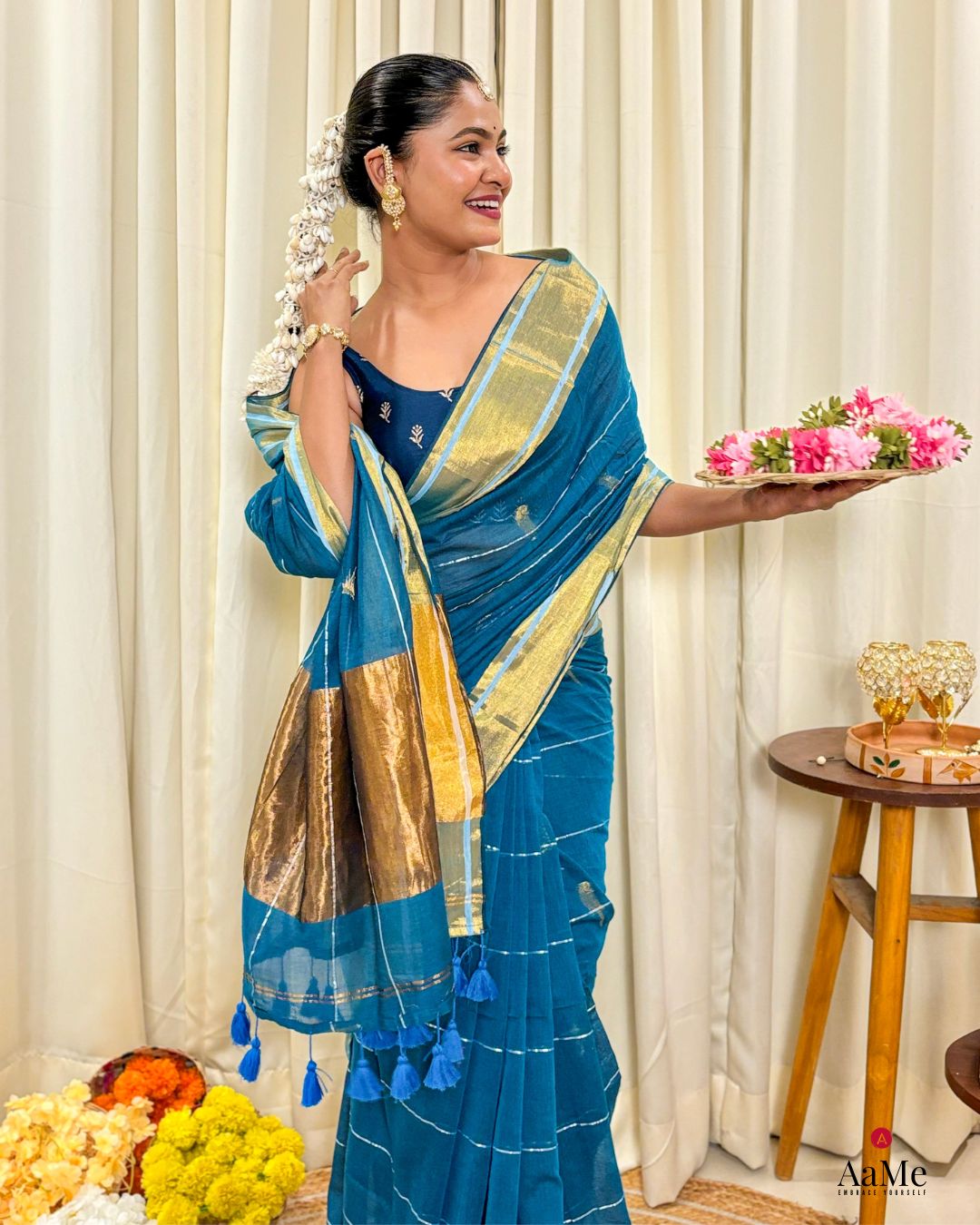 Women wearing elegant blue mulmul cotton saree with handcrafted finish for traditional daytime functions