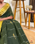 Close-up view of soft green mulmul cotton saree fabric with breathable texture