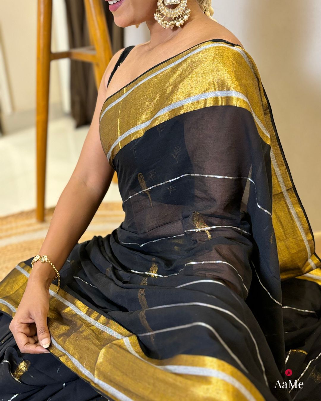 Women wearing soft black mulmul saree in breathable cotton, perfect for elegant evening celebrations
