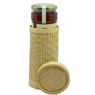Jar of jam with a woven cover on a white background