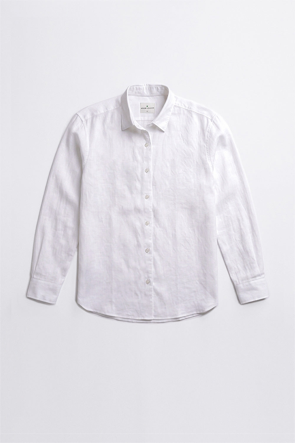 A white long-sleeve linen button-up linen shirt with a pointed collar, laid flat against a light gray background.