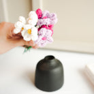 black bud vase with mini crochet daisies - https://artecasa.in/