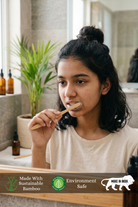 Woman brushing her teeth with a bamboo toothbrush in a bathroom setting using Eco-Friendly Bamboo Toothbrush by almitra sustainables