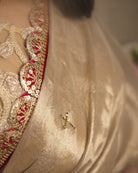 Mulmul Tissue Festive/Party Wear saree for the wedding season in  gold colour  with red Sari border and Zardozi/Jarsousi  work on entire saree, metallic finish