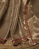 Mulmul Tissue Festive/Party Wear saree for the wedding season in  gold colour  with red Sari border and Zardozi/Jarsousi  work on entire saree, metallic finish