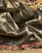 Mulmul Tissue Festive/Party Wear saree for the wedding season in dark liquid gold colour  with red Sari border and Zardozi/Jarsousi  work on entire saree, metallic finish