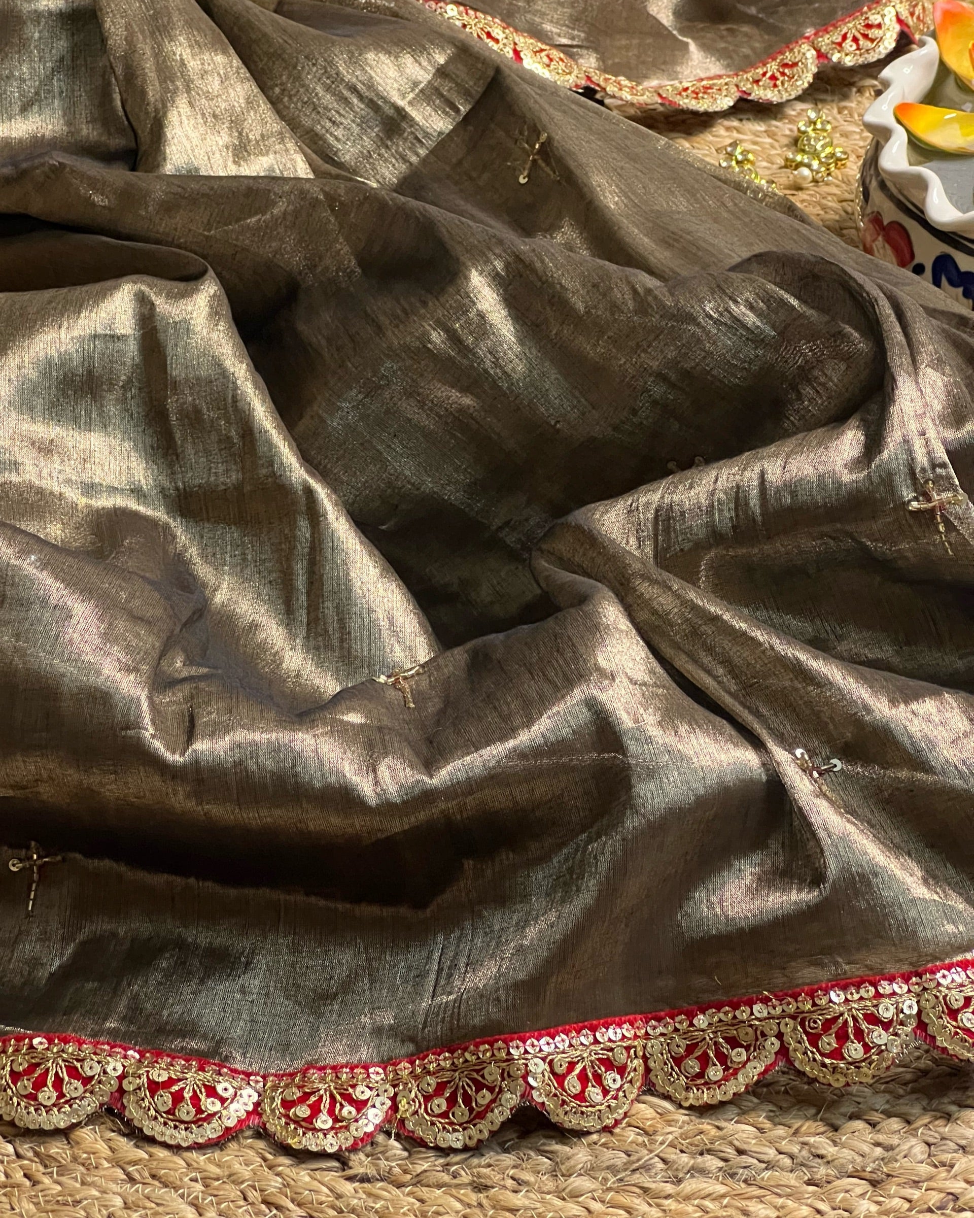 Mulmul Tissue Festive/Party Wear saree for the wedding season in dark liquid gold colour  with red Sari border and Zardozi/Jarsousi  work on entire saree, metallic finish