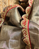 Mulmul Tissue Festive/Party Wear saree for the wedding season in dark liquid gold colour  with red Sari border and Zardozi/Jarsousi  work on entire saree, metallic finish
