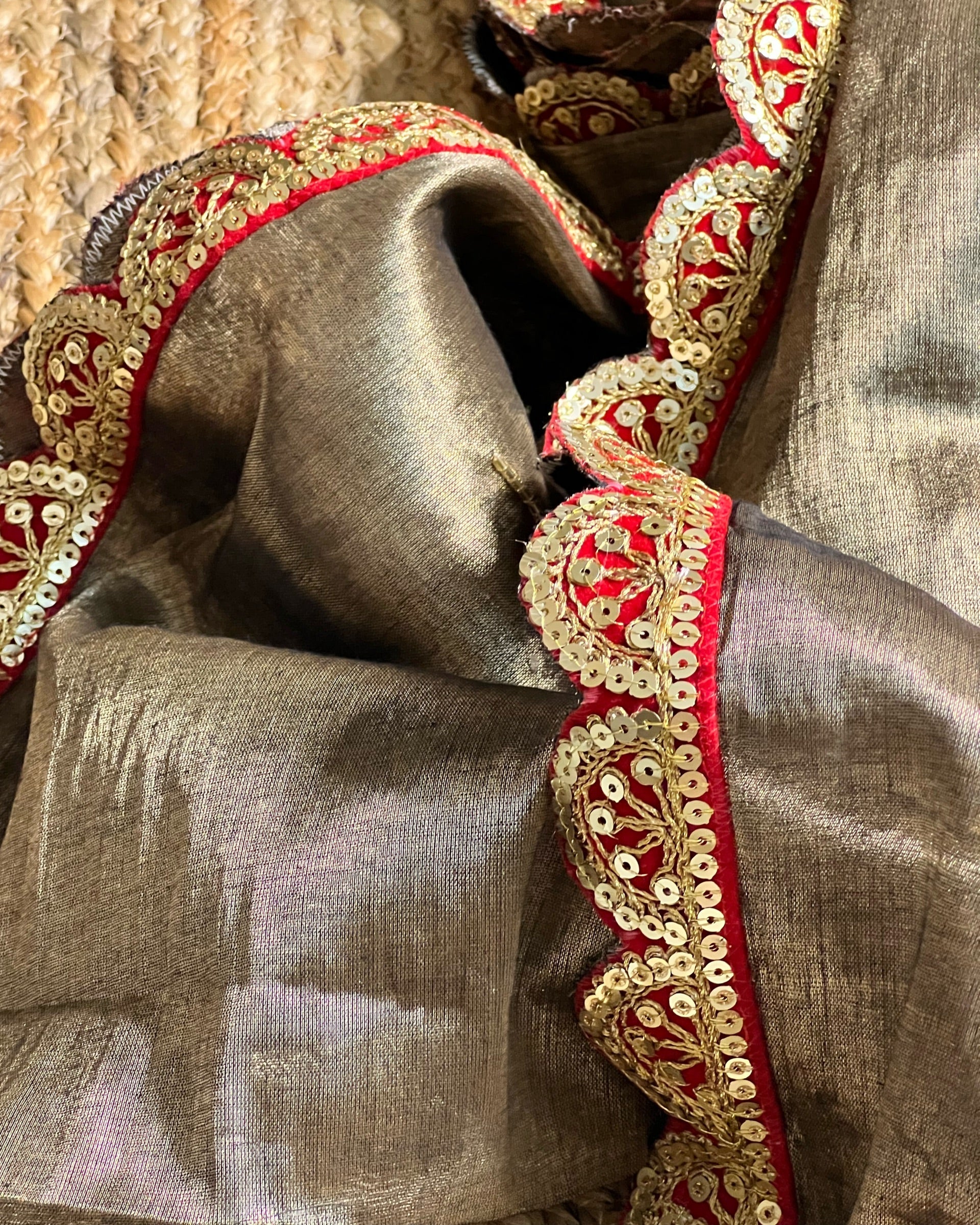 Mulmul Tissue Festive/Party Wear saree for the wedding season in dark liquid gold colour  with red Sari border and Zardozi/Jarsousi  work on entire saree, metallic finish