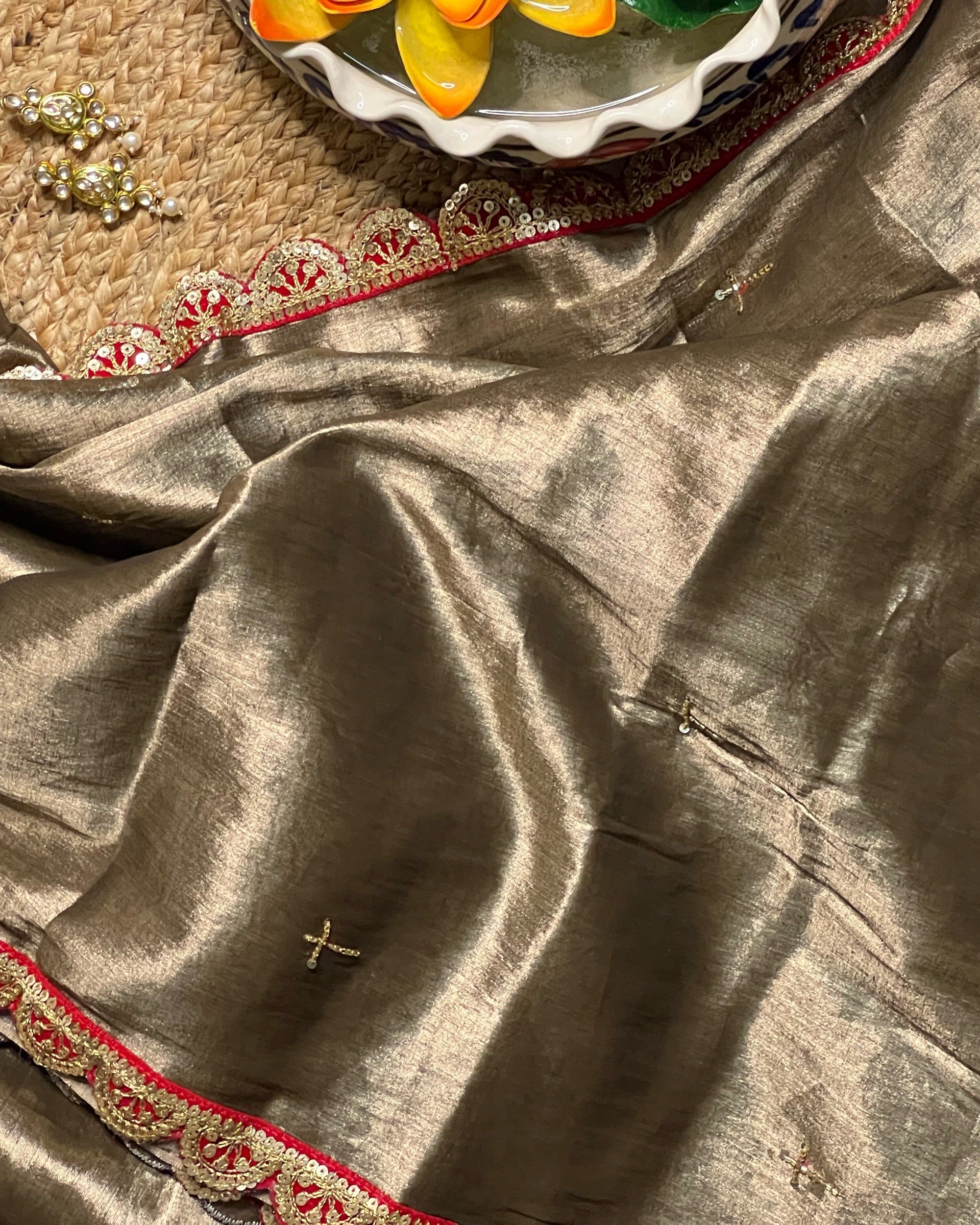 Mulmul Tissue Festive/Party Wear saree for the wedding season in dark liquid gold colour  with red Sari border and Zardozi/Jarsousi  work on entire saree, metallic finish