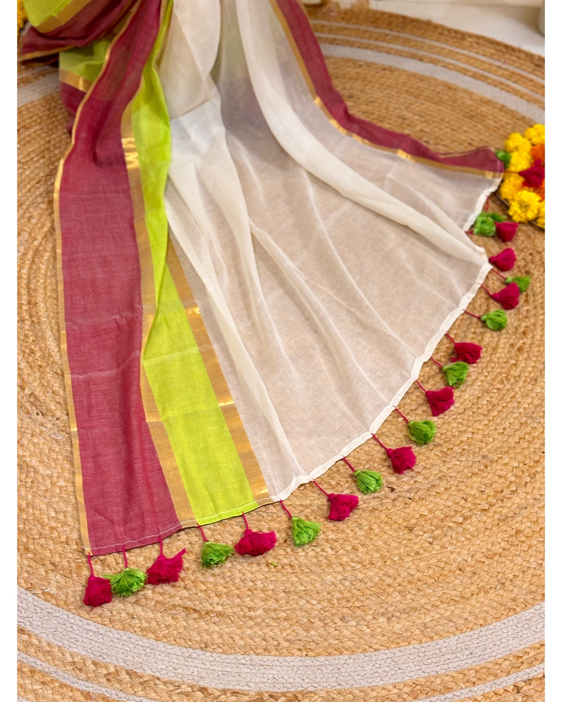Colorful saree with tassels on a woven surface