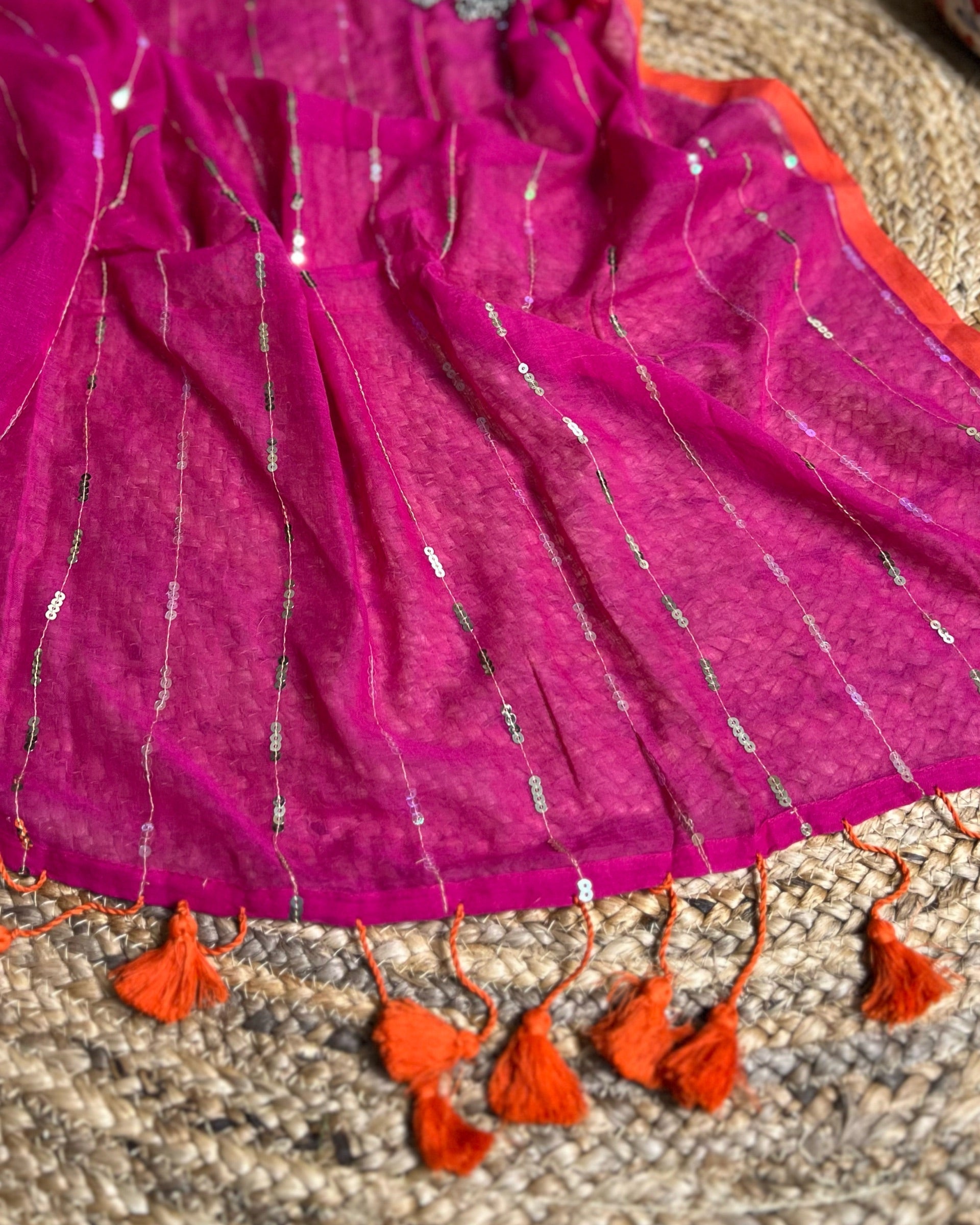 Soft and Comfortable mulmul cotton saree in pink rani shade with sequin emblishment for festive or party wear at reasonable price