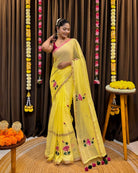 Yellow mulmul cotton saree with hand embroidered lotus motifs