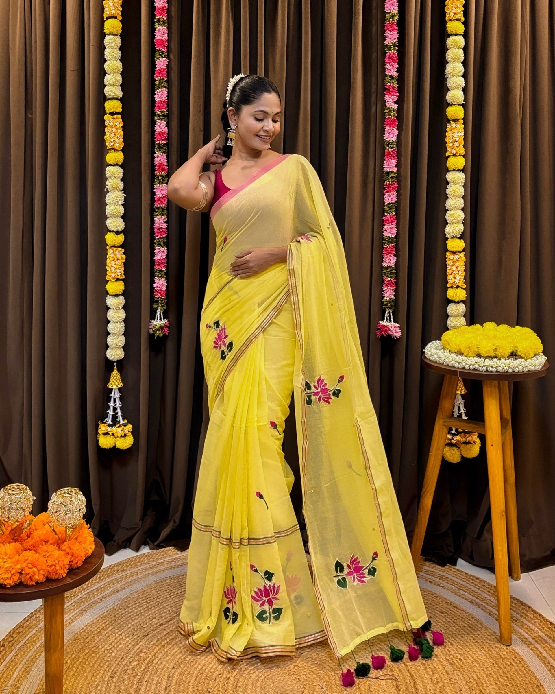 Yellow mulmul cotton saree with hand embroidered lotus motifs