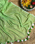 Soft and Comfortable mulmul cotton saree in green shade with sequin emblishment for festive or party wear at reasonable price
