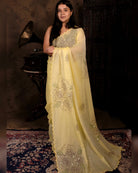 Lightweight yellow sequins embroidered mulmul cotton saree, designed for festive wear with a soft flowing drape.