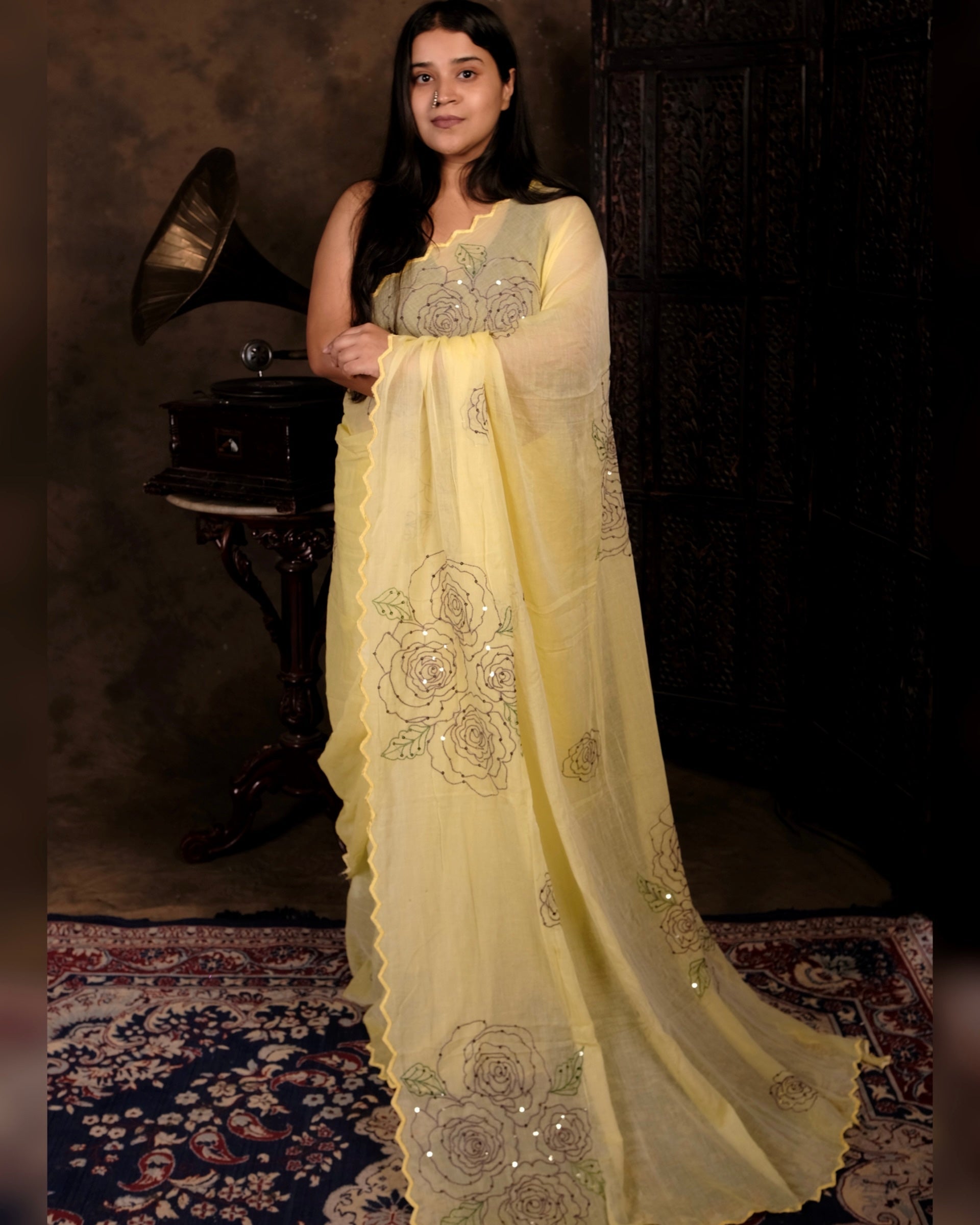 Lightweight yellow sequins embroidered mulmul cotton saree, designed for festive wear with a soft flowing drape.