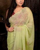 Lightweight green sequins embroidered mulmul cotton saree, designed for festive wear with a soft flowing drape.