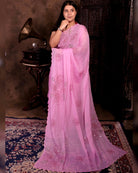Pink mulmul cotton saree with rose detailing and sequins embellishment, lightweight elegance for festive occasions and celebrations.