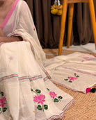 Minimal white mulmul saree with subtle lotus embroidery