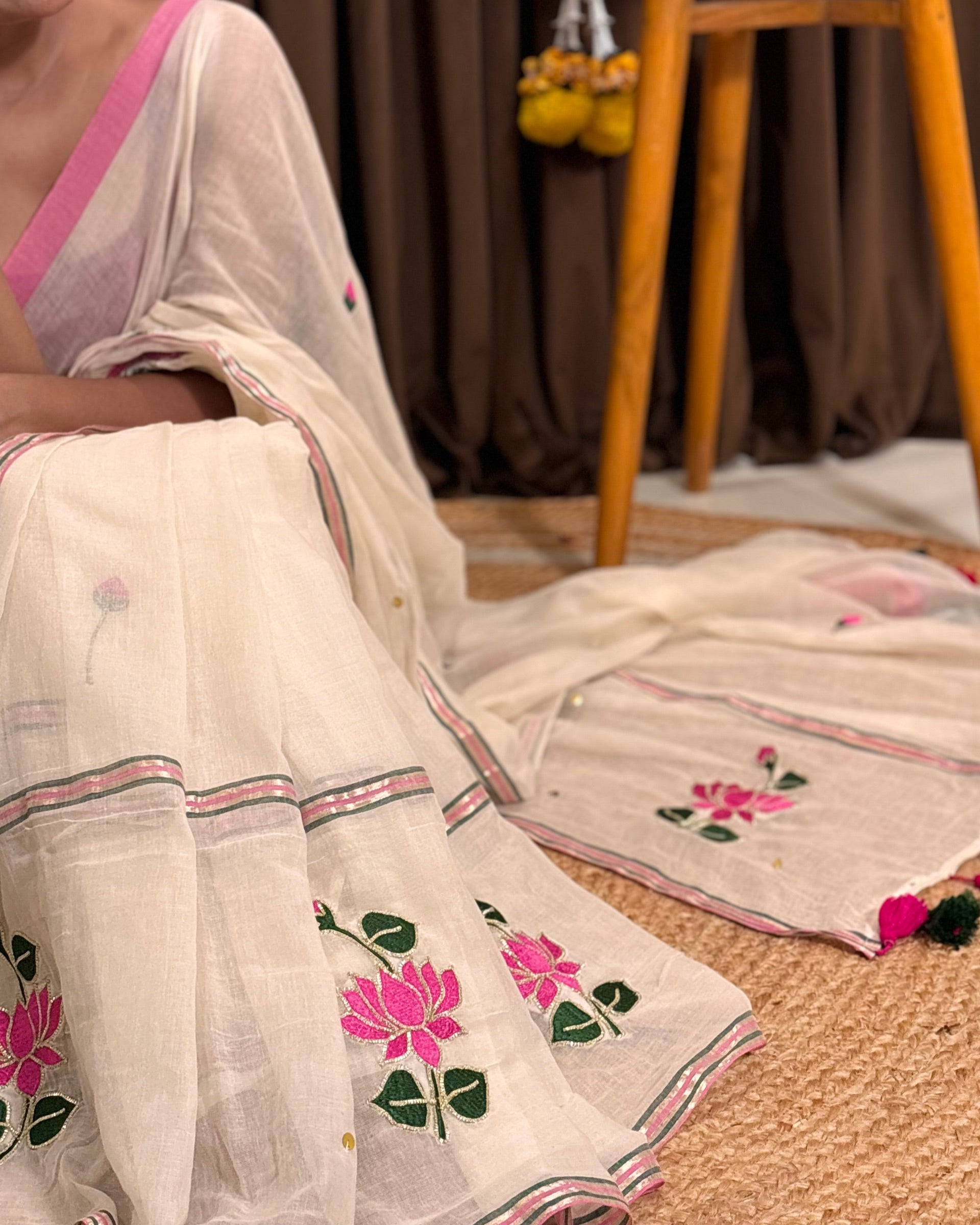 Minimal white mulmul saree with subtle lotus embroidery
