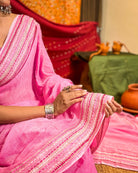 Model wearing Woven Halo pink mulmul cotton saree with graceful sequin detailing