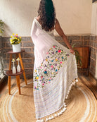 Handcrafted white saree featuring delicate floral embroidery from the Frosted Floral Muse collection