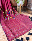 Handcrafted maroon mulmul cotton saree featuring soft breathable fabric and elegant thread work
