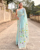 mulmul cotton saree in cyan with hand embroidered details