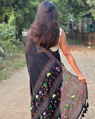 Lightweight black mulmul cotton saree with intricate embroidery for festive styling