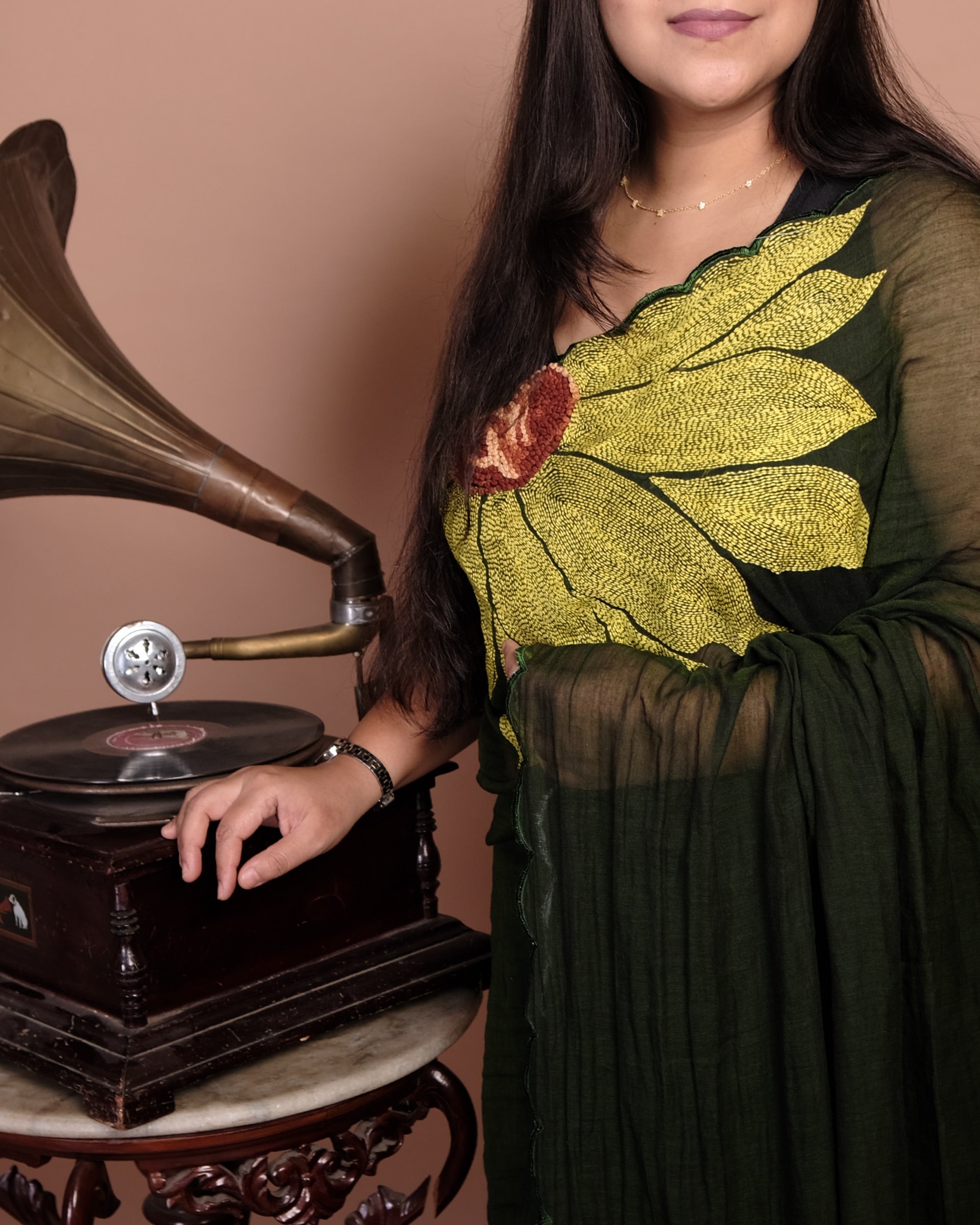 Green mulmul cotton saree with delicate embroidery, soft airy elegance for summer days and festive moments.