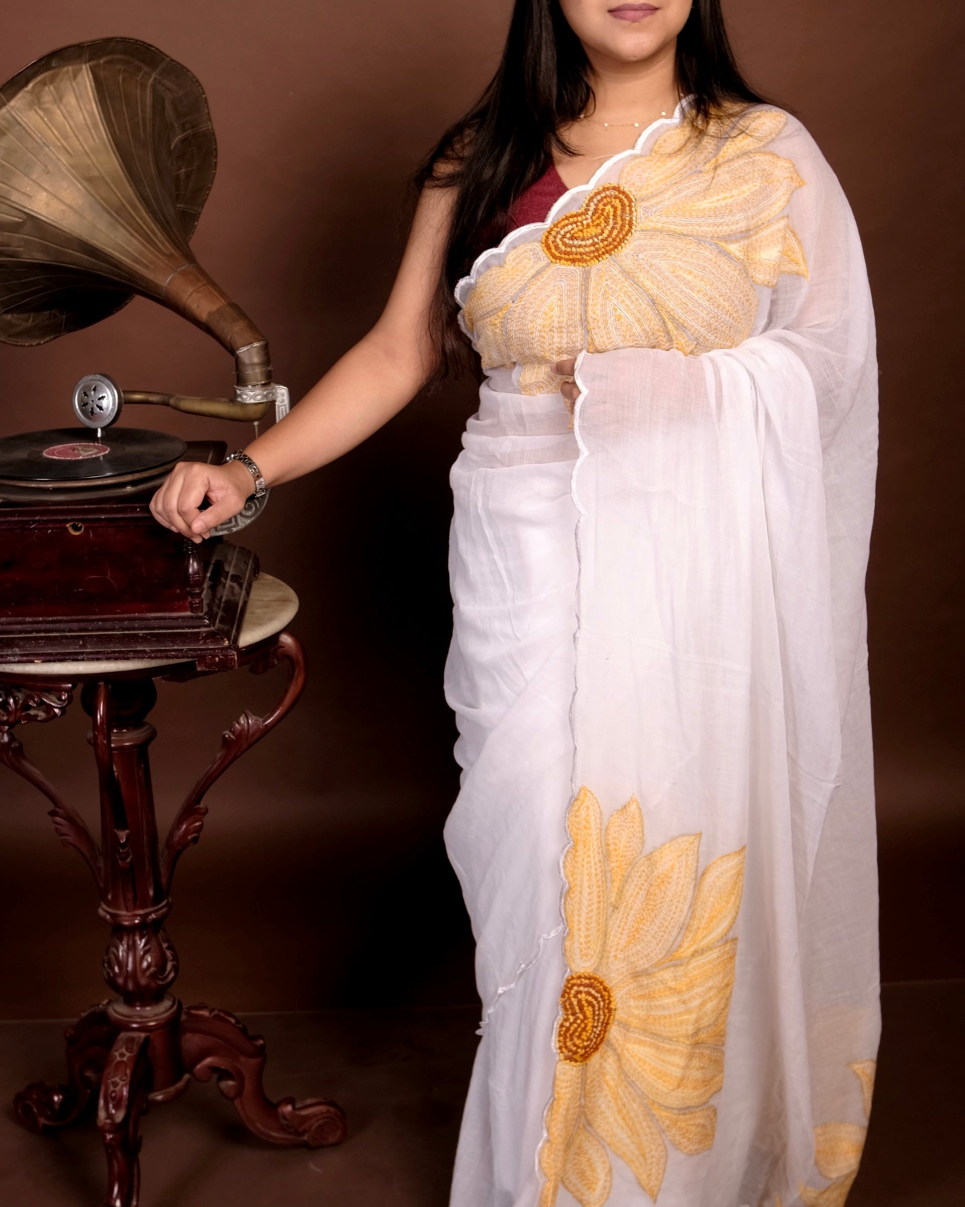White mulmul cotton saree with sunflower embroidery, soft airy elegance for summer styling and festive moments.