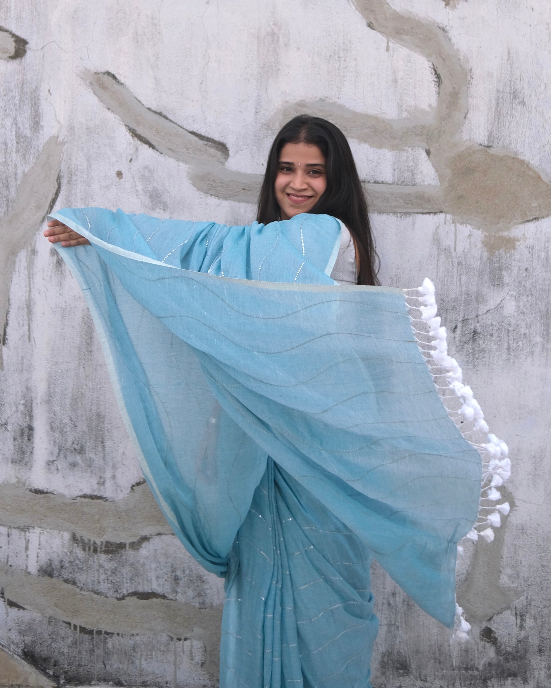 Soft and Comfortable mulmul cotton saree in sky blue shade with sequin emblishment for festive or party wear at reasonable price