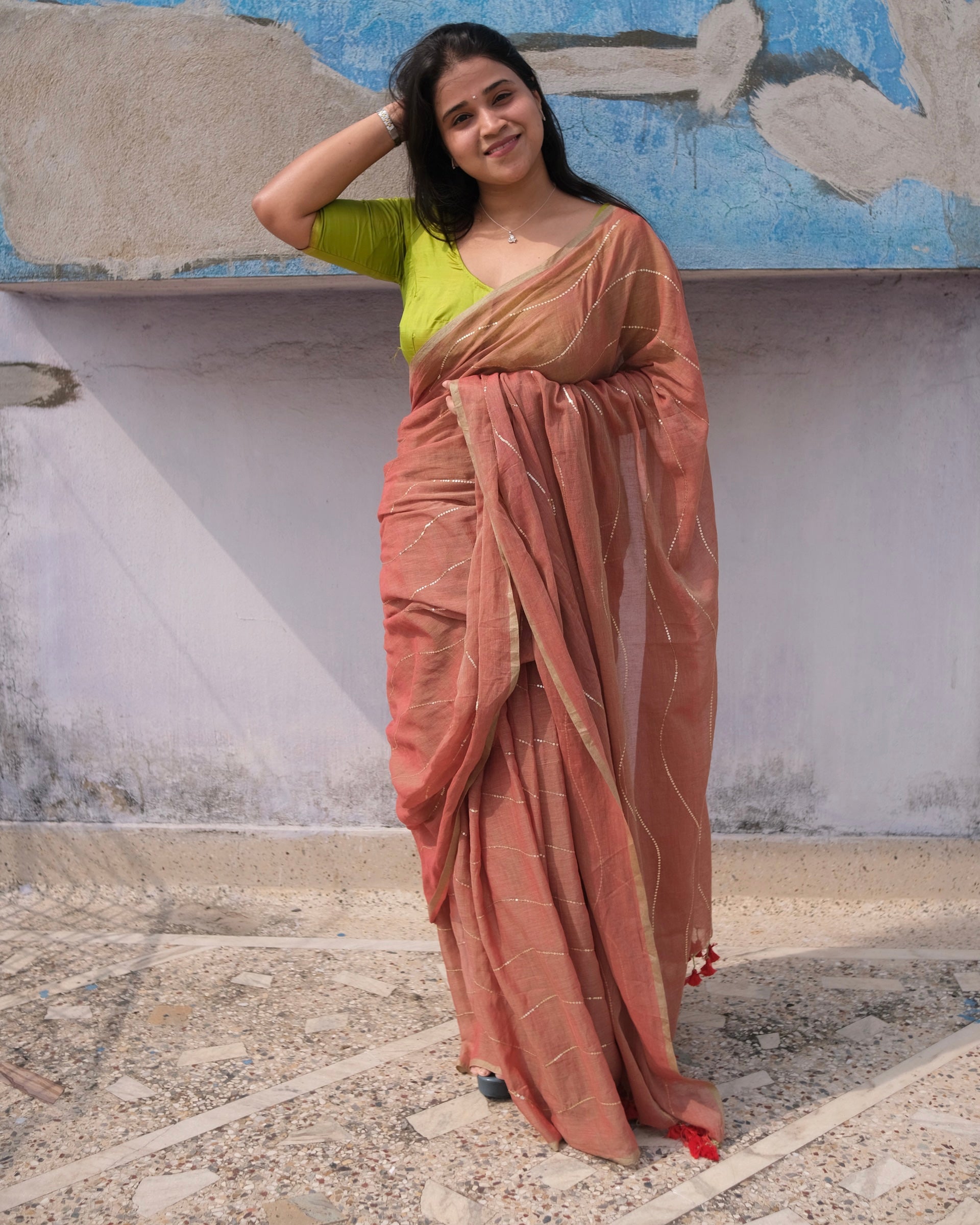 Soft and Comfortable mulmul cotton saree in dual tone peach and green shade with sequin emblishment for festive or party wear at reasonable price