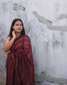 Soft and Comfortable mulmul cotton saree in maroon red shade with sequin emblishment by Shopaame for festive or party wear.