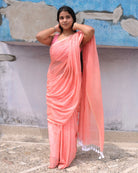 Soft and Comfortable mulmul cotton saree in peach pink shade with sequin emblishment for festive or party wear at reasonable price