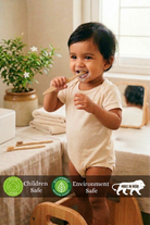 Child brushing teeth with a bamboo tooth brush in a bathroom setting, with 'Children Safe', 'Environment Safe', and 'Made in India' labels.