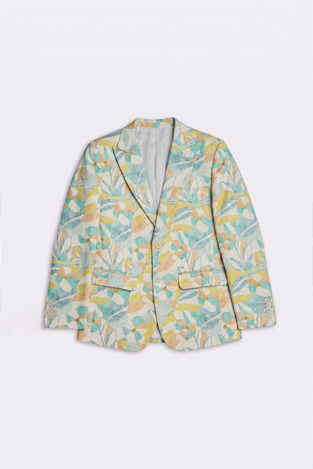 A women's single-breasted silk blazer with a tropical leaf pattern in shades of teal, yellow, and green on a light cream background, displayed flat against a light gray background.