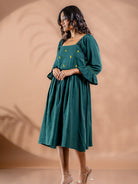 Side angle of Teal green embroidered  cotton tunic dress with flowy gathered silhouette and comfort fit. A must have summer staple for every wardrobe.