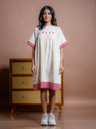 Best for your next outdoor outings, this off-white kala cotton tunic dress with hand embroidery is a must have wardrobe essential. Buy best Sustainable dresses in India.