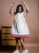 Off-white handwoven kala cotton hand embroidery knee length dress. Comfort fit, and best place to buy stylish and sustainable dresses in India.