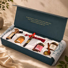Luxury forest gift hamper with premium honey, handcrafted treats, satin-lined presentation, elegant teal box, and artisanal accessories for meaningful gifting.