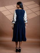 Back view of Selene black kala cotton midi dress showing flowy silhouette and gathered waist