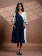Front view of Selene kala cotton summer dress showing embroidery and pocket details. 