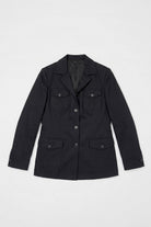 A black utility-style linen jacket with a pointed collar, front button closure, and four flap pockets, laid flat against a light gray background.